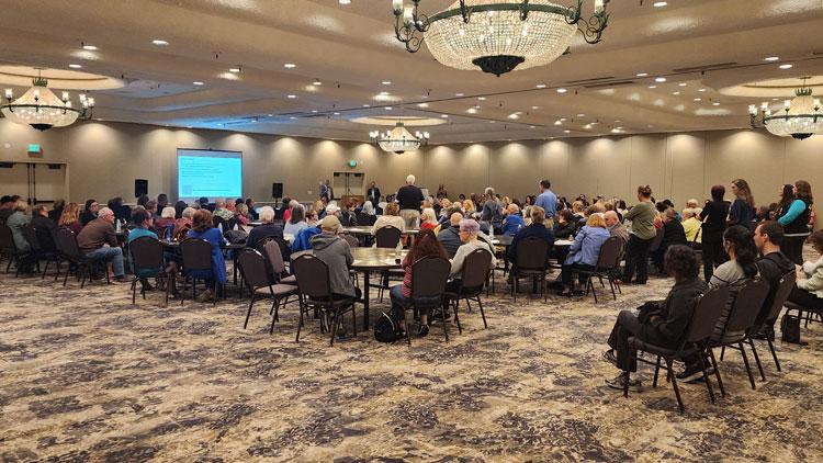 Residents of Concord in a large meeting room at a Community Engagement event on fair housing