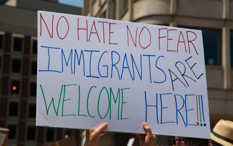 Photo of sign saying "No hate No fear Immigrants are welcome here!" Expressing support for immigrants.