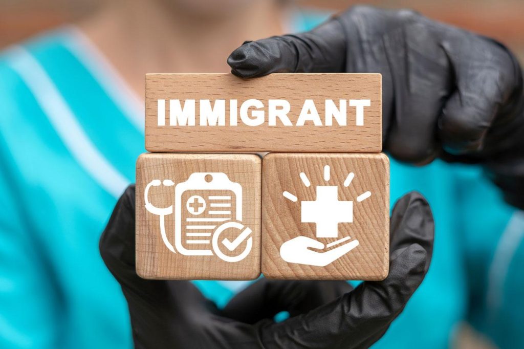 Nurse holding blocks with immigrant and healthcare symbols